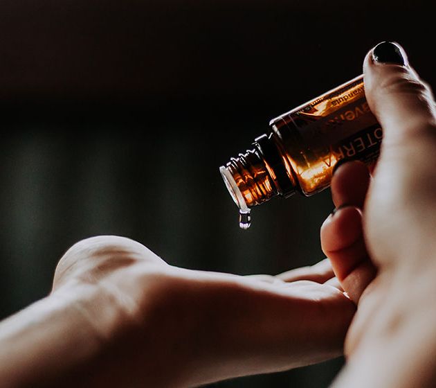 CBD oil being dripped on to a hand