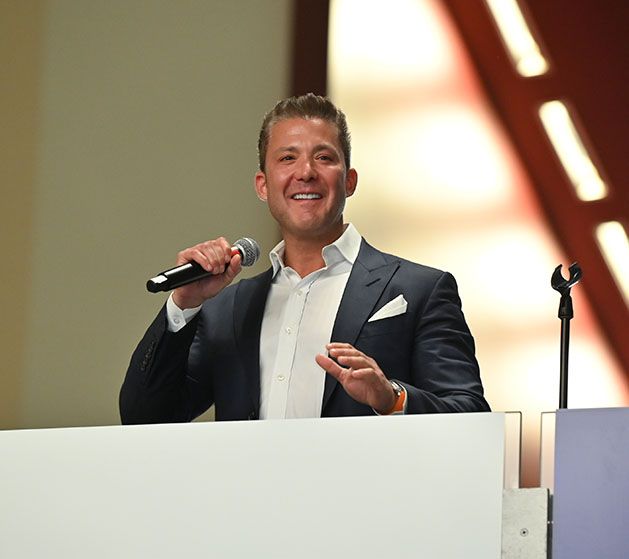 Marc Gardner speaking at a podium 