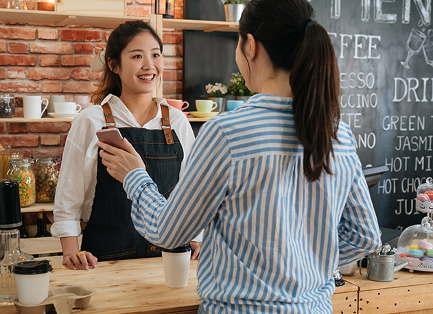 A woman paying for her coffee using a cash app