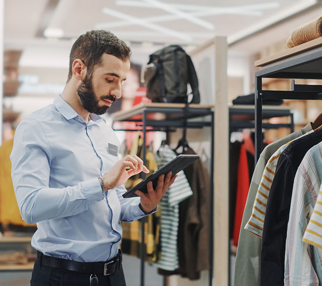 A shop clerk applying online discounts to items easily using North inventory management systems