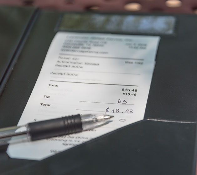 A restaurant receipt with tip added to it