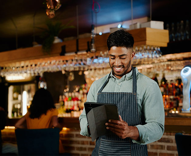 A server reviewing tickets and tabs using North POS software on his tablet