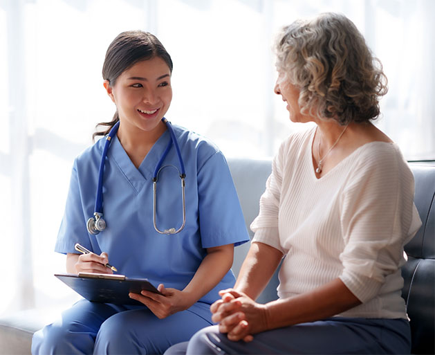 A healthcare professional showing a patient how to use contactless payments